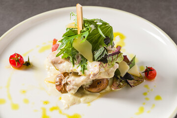Grilled chicken with mushrooms and cream sauce on a dark stone table