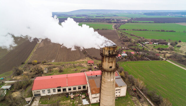 Aerial View of Industrial Chimney and Building Emitting Smoke