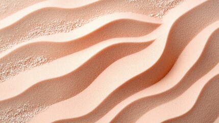 A textured surface of soft pink sand is gently sculpted with wavy designs and sprinkled with fine granules, creating a delicate and inviting abstract background.