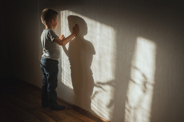 Little boy lonely depressed standing with back sitting on floor sad autism. autism spectrum...