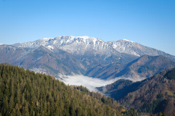 Obraz premium Frozen mountains from Bukov vrh in Slovenian spring