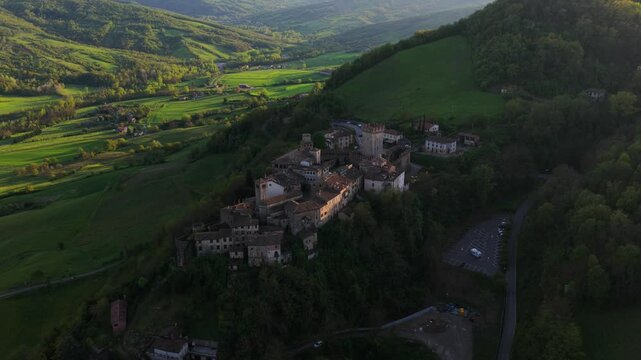 Aerial View Of Vigoleno In Piacenza, Italy - Medieval Village On Green Hillside. pullback tilt-up shot