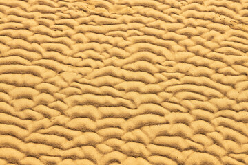 Top view of golden sand on ocean beach