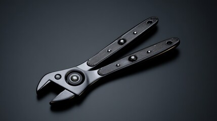 Obraz premium A sleek black adjustable wrench on a dark background, perfect for industrial use.