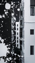 White inkblots over black turning into glowing white buildings wallpaper background vertical design concept