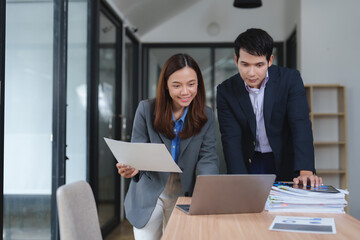 Business professionals collaborating on a project in office