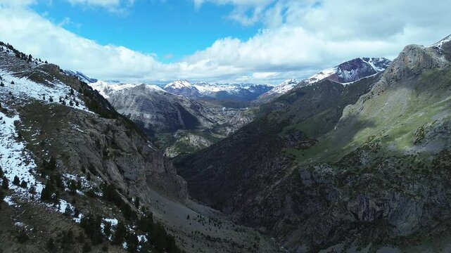 Majestic aerial view of Valle de Izas with snowy peaks and Candanch&uacute; in the distance
