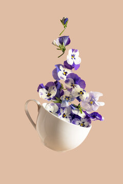 Abstract levitation purple pancy flying flowers in tea cup