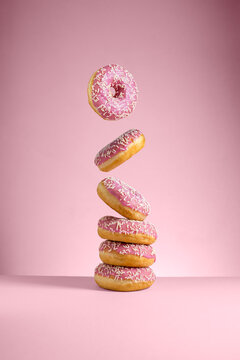 Abstract pink donuts isolated on pink background levitation