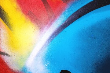 Expressive street wall with colorful graffiti in red, yellow, and blue. 2000s-inspired grunge...