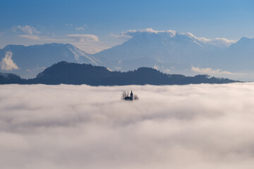 St.Thomas church in morning fog near Skofja Loka in Slovenia