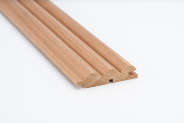 Decorative wooden trim piece with a scalloped profile, made from medium-toned wood, isolated on white background for product presentation..