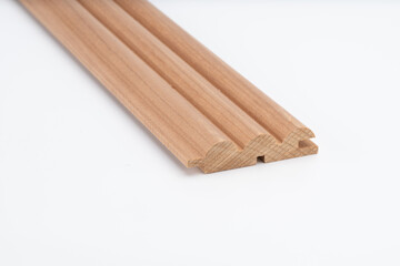 Decorative wooden trim piece with a scalloped profile, made from medium-toned wood, isolated on white background for product presentation..