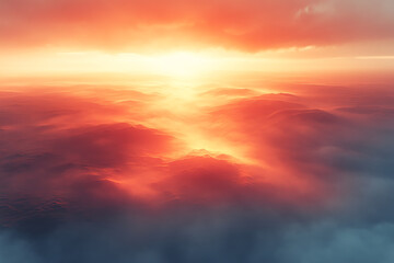 Fototapeta premium A breathtaking aerial view of a vibrant sunset illuminating the clouds with warm hues of orange and pink, reflecting serene beauty.