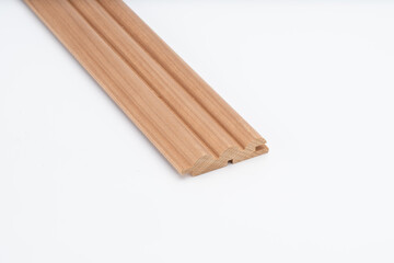 Decorative wooden trim piece with a scalloped profile, made from medium-toned wood, isolated on white background for product presentation..