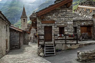 Alpine stone village with old church among old stone houses in Bonneval sur Arc, France.
