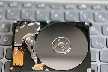 computer hard disk in close-up, disassembled, view inside, computer memory disk