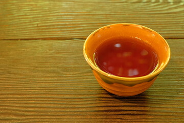Cold roasted green tea poured into a Japanese teacup	
