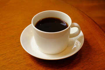 cup of coffee on wooden table	
