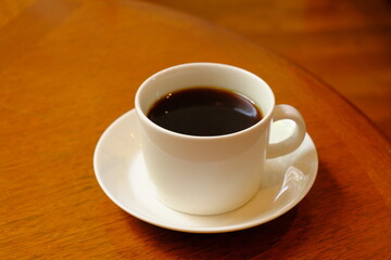 cup of coffee on wooden table	
