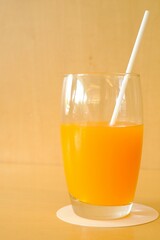 a glass of orange juice on the table 