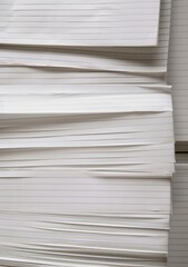 A stack of lined, white paper sheets piled on top of each other.