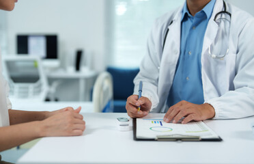 Doctor explaining medical chart to patient during consultation in clinic