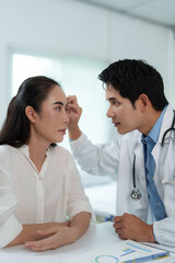 Doctor examining patient's face in medical clinic