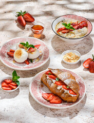 croissant with strawberries and mascarpone and cheesecakes with strawberries