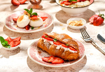 croissant with strawberries and mascarpone and cheesecakes with strawberries