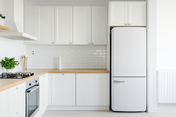 Modern trendy kitchen design with white cabinets. Subway tile backsplash, marble countertop. No brands or labels. Neutral contemporary design. Simply furniture with utensils, crockery, refrigerator.