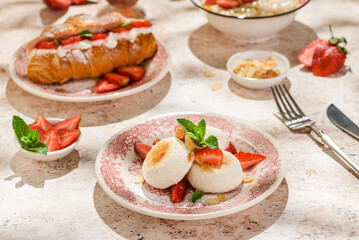 cottage cheese cheesecakes with strawberries, croissant and porridge with strawberries. breakfast...
