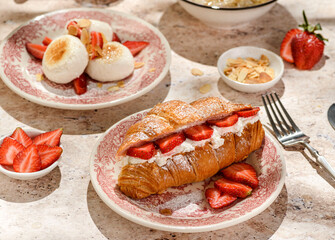 croissant with strawberries and mascarpone and cheesecakes with strawberries