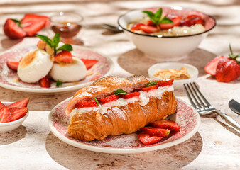 croissant with strawberries and mascarpone and cheesecakes with strawberries