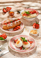 cottage cheese cheesecakes with strawberries, croissant and porridge with strawberries. breakfast...