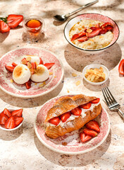 croissant with strawberries and mascarpone and cheesecakes with strawberries