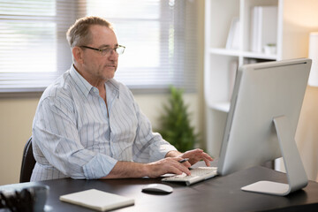 Fototapeta premium A businessman is sitting at his desk working.