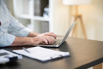 A businessman is sitting at his desk working.