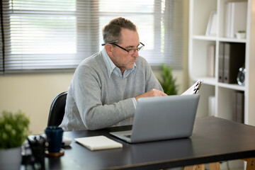 Fototapeta premium A businessman is sitting at his desk working.
