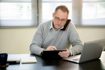 A businessman is sitting at his desk working.