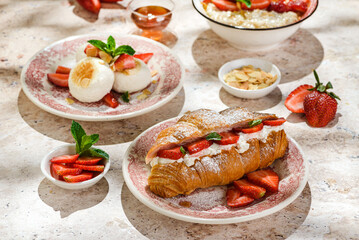 croissant with strawberries and mascarpone and cheesecakes with strawberries