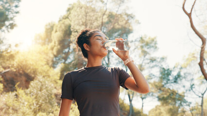 Woman, drinking water and thirsty in nature for fitness, electrolytes and body detox. Low angle,...