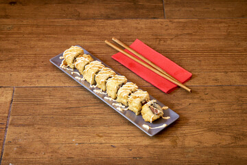 A plate of sushi with chopsticks on a red napkin.