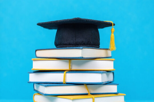 stack of books with a graduation cap on top5