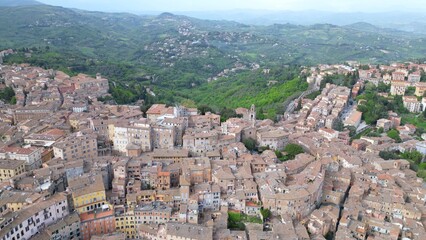 Fototapeta premium Drone aerial view of the historic center of Perugia with the houses perched on the hills of the Umbrian Apennines with the houses with the typical tiled roofs matching each other - Piazza IV Novembre