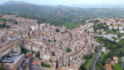 Obraz premium Drone aerial view of the historic center of Perugia with the houses perched on the hills of the Umbrian Apennines with the houses with the typical tiled roofs matching each other - Piazza IV Novembre