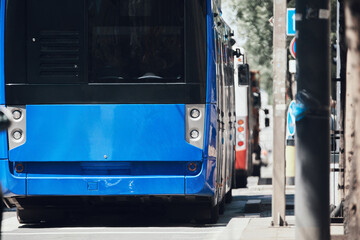 Blue bus for public transportation on city streets.