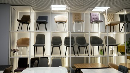 Modern chairs displayed on shelves in furniture store