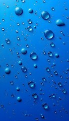 Numerous clear water droplets scattered across a vibrant blue background. 