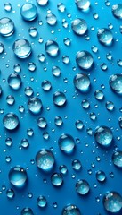 Numerous clear water droplets on a vibrant blue background, creating a fresh and sparkling scene. 